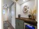 Hallway with storage cabinets, a counter with a mini fridge, and modern decor at 1103 S Monaco Pkwy, Denver, CO 80224