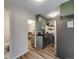 Open-concept kitchen design with light green cabinets and stainless-steel appliances, seamlessly flowing into the adjacent dining area at 1103 S Monaco Pkwy, Denver, CO 80224