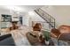 Open concept living area features modern design, hardwood floors and stairway with rod iron balusters at 1103 S Monaco Pkwy, Denver, CO 80224