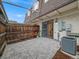 Outdoor patio featuring brick walls, a wooden fence, and air conditioning unit at 1103 S Monaco Pkwy, Denver, CO 80224