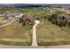 Aerial view of a grand home with a long driveway and surrounding green lawns at 19735 Knights Xing, Monument, CO 80132