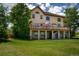 Lush green backyard featuring a multi-level deck and the exterior of the home at 19735 Knights Xing, Monument, CO 80132