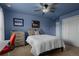 Comfortable bedroom featuring a ceiling fan, neutral carpet, and closet space at 19735 Knights Xing, Monument, CO 80132