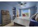 Bright bedroom with built in shelves, a ceiling fan, and a window that fills the room with natural light at 19735 Knights Xing, Monument, CO 80132
