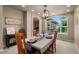 Cozy dining room boasts a rustic chandelier and natural light at 19735 Knights Xing, Monument, CO 80132