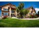Gorgeous home featuring lush lawn, stone accents, and a covered front porch at 19735 Knights Xing, Monument, CO 80132
