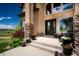 Elegant front entrance with stone accents, a welcoming porch, and beautiful flower planters at 19735 Knights Xing, Monument, CO 80132