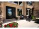 Inviting front porch with seating area and double door entry, enhanced by beautiful landscaping at 19735 Knights Xing, Monument, CO 80132