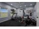 Brightly lit home gym with treadmill, elliptical, pull-down and weight machines at 19735 Knights Xing, Monument, CO 80132