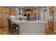 Spacious kitchen features custom wood cabinets, stainless steel appliances, and a large center island with seating at 19735 Knights Xing, Monument, CO 80132