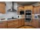 The kitchen has stainless steel appliances, granite countertops, and custom wood cabinetry at 19735 Knights Xing, Monument, CO 80132