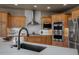 A closer look at the kitchen with stainless steel appliances and sleek black fixtures at 19735 Knights Xing, Monument, CO 80132