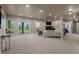Spacious living room with access to backyard, cozy fireplace, tv and adjacent workout room at 19735 Knights Xing, Monument, CO 80132