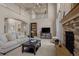 Comfortable living room with a cozy fireplace, high ceilings, and open staircase at 19735 Knights Xing, Monument, CO 80132