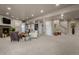 Expansive living room featuring a fireplace, recessed lighting, staircase, and neutral carpet at 19735 Knights Xing, Monument, CO 80132