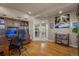 Spacious home office featuring wood floors, built-in shelving, and French doors at 19735 Knights Xing, Monument, CO 80132