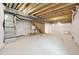 Unfinished basement with concrete floors, exposed wood beams and utilities at 7312 Watercress Dr, Littleton, CO 80125