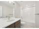 A newly updated bathroom with single vanity, tiled shower-tub, and chrome fixtures at 7312 Watercress Dr, Littleton, CO 80125