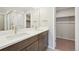 Bright bathroom featuring a double vanity with undermount sinks and modern fixtures at 7312 Watercress Dr, Littleton, CO 80125