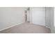 A secondary bedroom with carpet flooring and a sliding door closet at 7312 Watercress Dr, Littleton, CO 80125