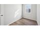 Empty bedroom with hardwood floors and a bright window at 7312 Watercress Dr, Littleton, CO 80125
