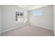 A bedroom with neutral carpeting and two windows for natural light at 7312 Watercress Dr, Littleton, CO 80125