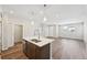 Modern kitchen with an island bar, stainless steel appliances, hardwood flooring and recessed lighting at 7312 Watercress Dr, Littleton, CO 80125