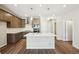 Spacious kitchen featuring a central island, stainless steel appliances, and stylish pendant lighting at 7312 Watercress Dr, Littleton, CO 80125