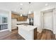 Modern kitchen with stainless steel appliances, a kitchen island, and wood flooring at 7312 Watercress Dr, Littleton, CO 80125