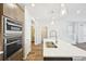 Bright kitchen featuring modern appliances, an island and stylish pendant lighting at 7312 Watercress Dr, Littleton, CO 80125