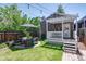 Backyard patio with outdoor furniture, string lights, grass and mature landscaping at 2941 Glenarm Pl, Denver, CO 80205