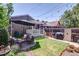 A delightful backyard featuring a cozy patio set, a lush lawn, and charming garden beds at 2941 Glenarm Pl, Denver, CO 80205