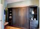 Bedroom showcases a Murphy bed, complemented by custom shelving at 2941 Glenarm Pl, Denver, CO 80205