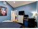 Comfortable blue bedroom with decor and access to a kitchenette area at 2941 Glenarm Pl, Denver, CO 80205