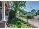 Well-maintained front yard with lush greenery and a charming wrought iron fence at 2941 Glenarm Pl, Denver, CO 80205