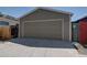 A detached garage with a large roll-up door at 2941 Glenarm Pl, Denver, CO 80205