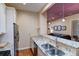 Updated kitchen with granite counters, stainless appliances, and open layout to the living space at 2941 Glenarm Pl, Denver, CO 80205