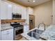Modern kitchen features stainless steel appliances, granite countertops, and ample storage space at 2941 Glenarm Pl, Denver, CO 80205