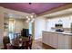 Inviting kitchen with granite counters and stainless appliances, conveniently opens to the dining area at 2941 Glenarm Pl, Denver, CO 80205