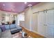 Bright living room with hardwood floors, barn doors, and comfortable modern furnishings at 2941 Glenarm Pl, Denver, CO 80205