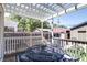 View of the backyard from the porch with a dark metal outdoor table and four chairs at 2941 Glenarm Pl, Denver, CO 80205