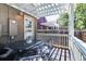 Enclosed porch with pergola, table and chairs and an outdoor light at 2941 Glenarm Pl, Denver, CO 80205