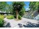 Backyard with a painted mural, a wooden deck and surrounding trees at 990 S Jackson St, Denver, CO 80209