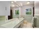 Bathroom featuring a vanity, large mirror and plentiful lighting at 990 S Jackson St, Denver, CO 80209