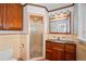 Bathroom features vanity lighting, updated fixtures, and a glass-enclosed shower at 990 S Jackson St, Denver, CO 80209