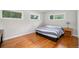 Bright bedroom with two windows, hardwood flooring, and contemporary decor at 990 S Jackson St, Denver, CO 80209