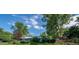 A single-story home surrounded by mature trees and lush landscaping, offering a serene and private setting at 990 S Jackson St, Denver, CO 80209