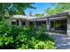 Exterior of the home showing a patio, backyard and greenery at 990 S Jackson St, Denver, CO 80209