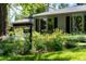 Charming house number sign surrounded by colorful flowerbeds and lush landscaping enhancing the curb appeal at 990 S Jackson St, Denver, CO 80209