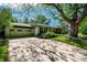 Charming home featuring a two-car garage, a spacious driveway, mature shade trees, and manicured lawn at 990 S Jackson St, Denver, CO 80209